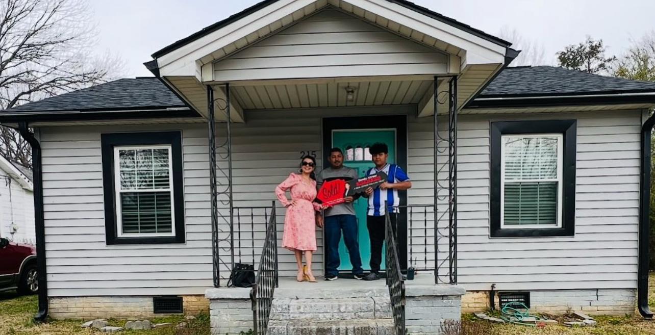 Sandy Alvear with clients at Norwood Armstrong and Stokes — Sold sign celebration
